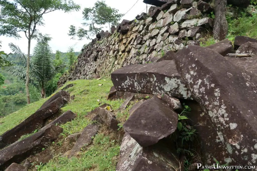 Polygonal basalt logs stacked along the side of one of the terraces.