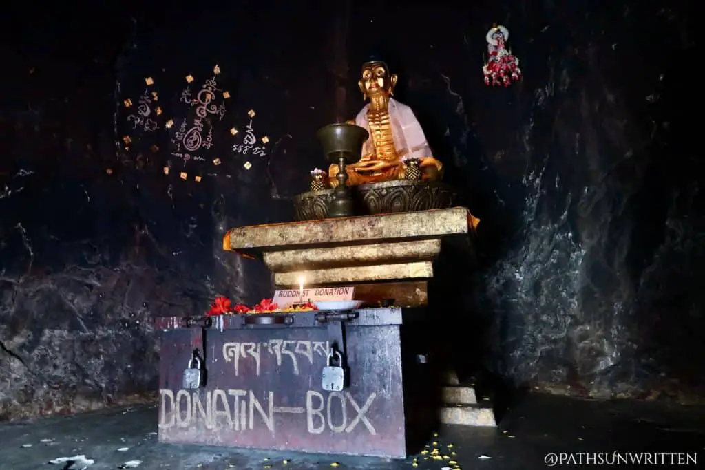 The golden ascetic Siddhartha Gautama statue inside the main cave