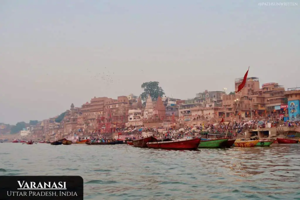The colorful ghats of Varanasi from the Ganges River at sundown.