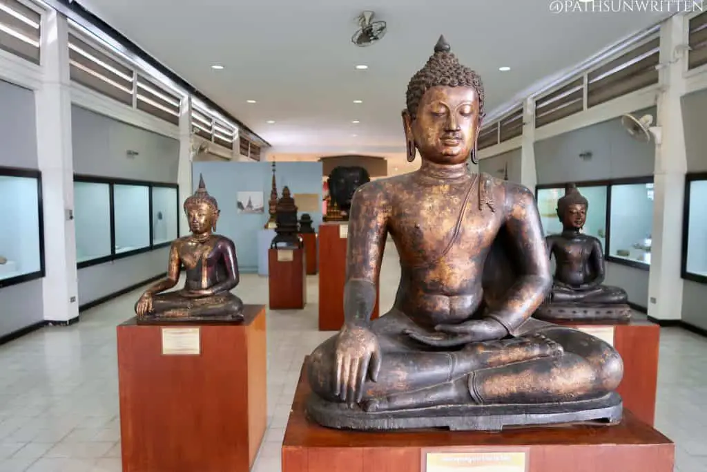 Cast bronze Buddha images from ancient Lamphun on display at the Hariphunchai National Museum.