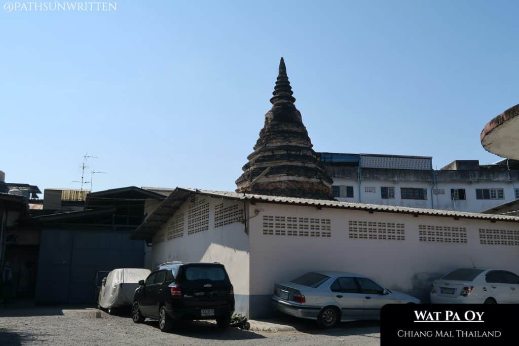The Wat Pa Oy stupa is surrounded on all sides by buildings.
