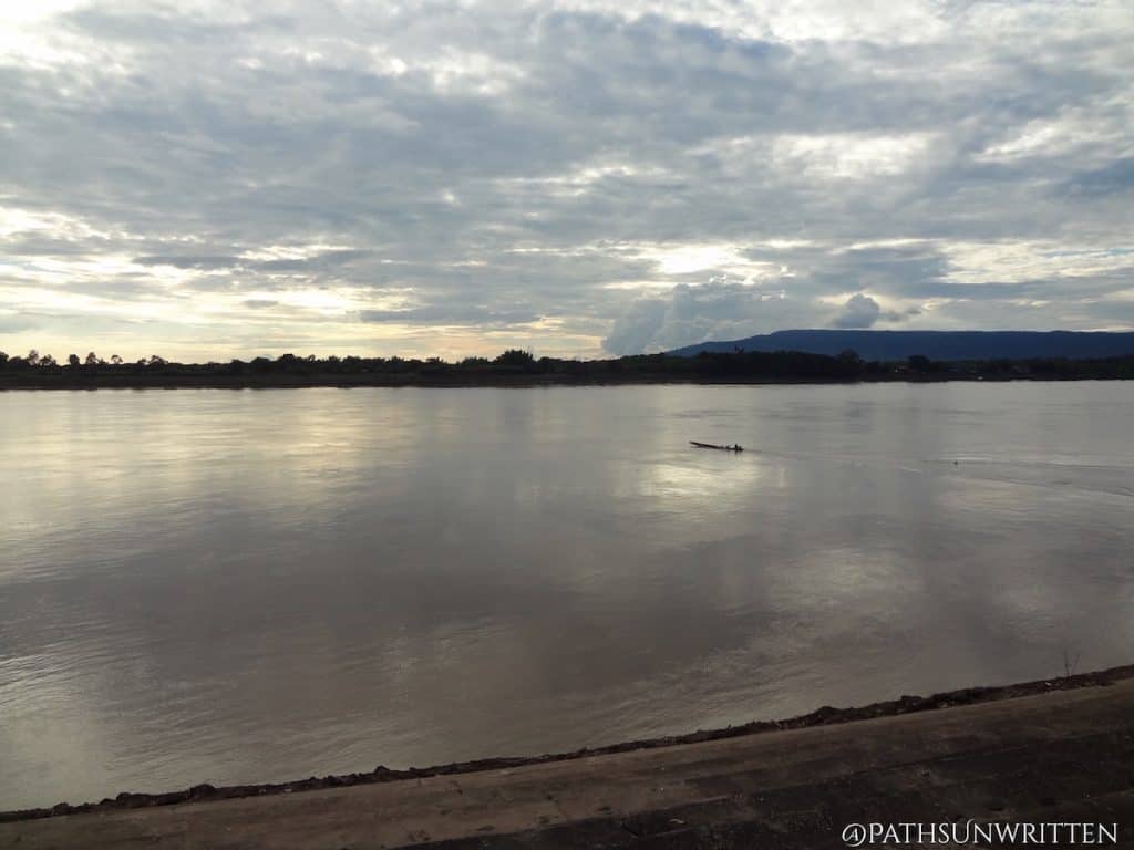 A small boat crossing the Mekong at sunset in Nong Khai Province